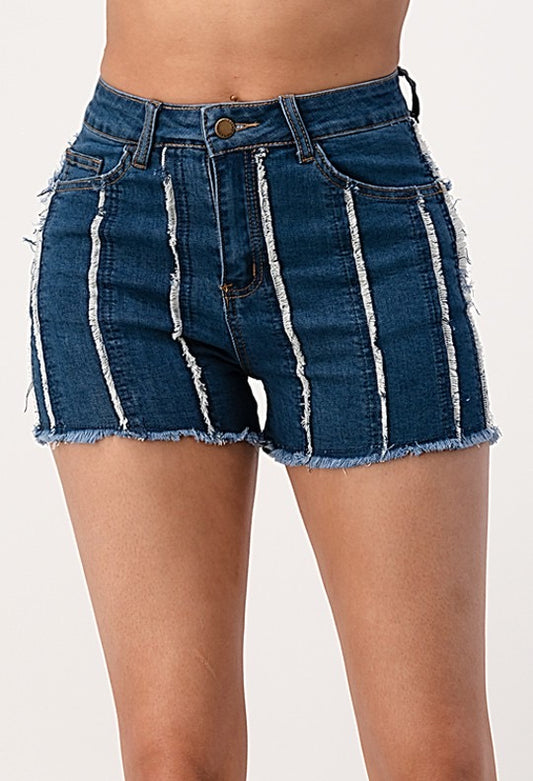 Front closeup of the denim shorts. The shorts display a vertically striped distress pattern.